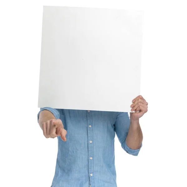Young Casual Man Covering Face Empty Board Pointing Finger Standing Stock Photo
