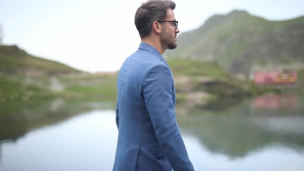 Cool Smart Casual Businessman Walking Lake Mountains Sticking His Hands — Stock Video