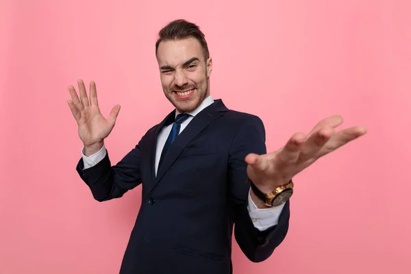 Enthusiastic Young Guy Suit Holding Hands Air Presenting Standing Pink — Stock Photo, Image