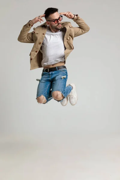 Cool Casual Guy Jacket Wearing Sunglasses Looking Side Jumping Air — Stock Photo, Image