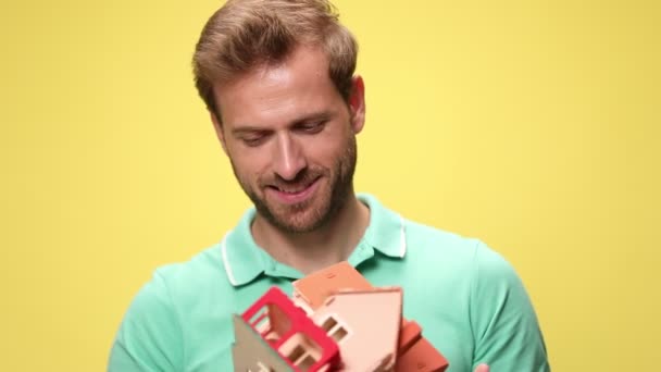 Mladý Ležérní Muž Polo Shirt Držení Doporučení Domu Úsměv Žlutém — Stock video