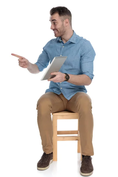 Gelukkig Slim Casual Man Holding Tablet Wijzend Weg Glimlachen Terwijl — Stockfoto