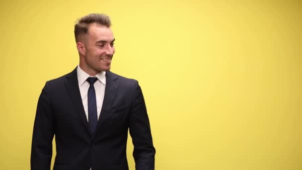 Handsome Businessman Presenting Something Side Yellow Background — Stock Video