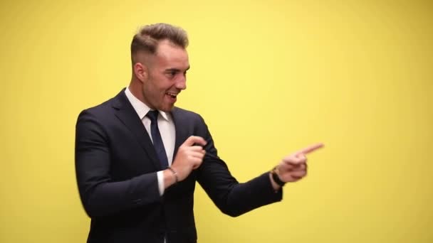 Businessman Pointing Repeatedly Side Pointing Giving Thumbs Yellow Background — Stock Video