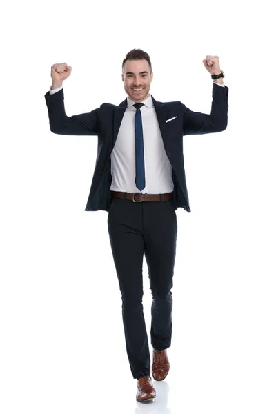 Hombre Negocios Sonriente Celebrando Con Ambos Puños Aire Mientras Camina —  Fotos de Stock