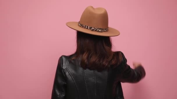 Back View Cool Girl Leather Jacket Turning Throwing Hat Smiling — Stock Video