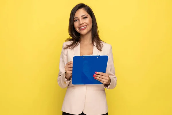 Happy Young Businesswoman Pink Suit Taking Notes Clipboard Smiling Yellow — Stock Photo, Image