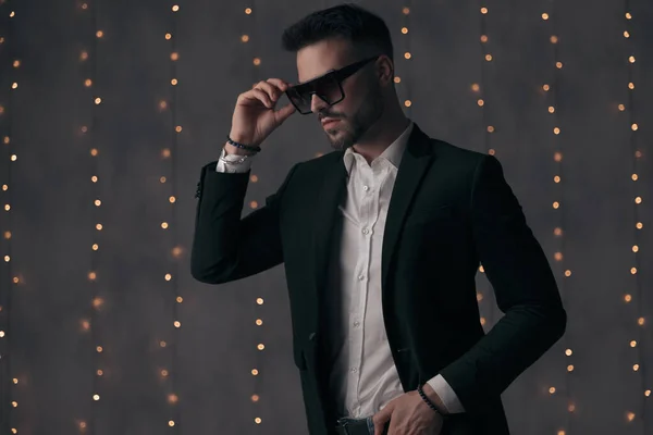 Confident Fashion Model Taking His Sunglasses Looking Away While Standing — Stock Photo, Image