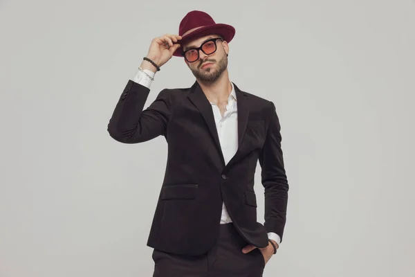 Confident Fashion Model Taking Hat Hand Pocket Wearing Sunglasses While — Stock Photo, Image