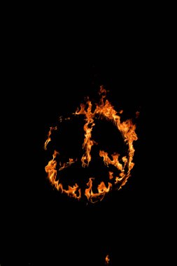Burning peace symbol over black background clipart