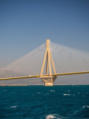 the Rio Antirio bridge or Charilaos Trikoupis bridge, one of the longest cable - stayed bridges of the world, crosses the Gulf of Corinth and linking the Peloponnese with the mainland Greece clipart