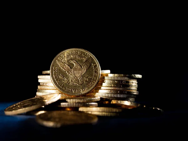 Real Gold coins over dark background