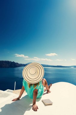 Luxury travel vacation woman looking at view on Santorini island in Greece. Amazing view of sea and Caldera. clipart