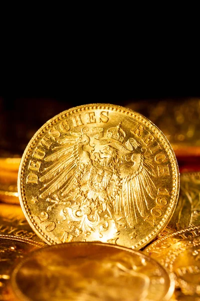 Real Gold coins over dark background