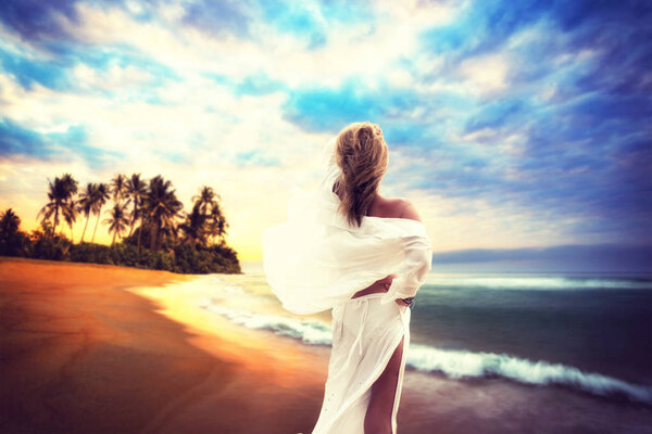 Woman on the beach at sunset in south east Asia