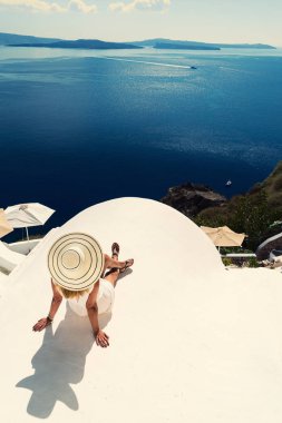 Luxury travel vacation woman looking at view on Santorini island clipart