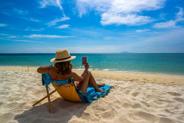 Женщина наслаждается отдыхом на трансате на тропическом пляже
 