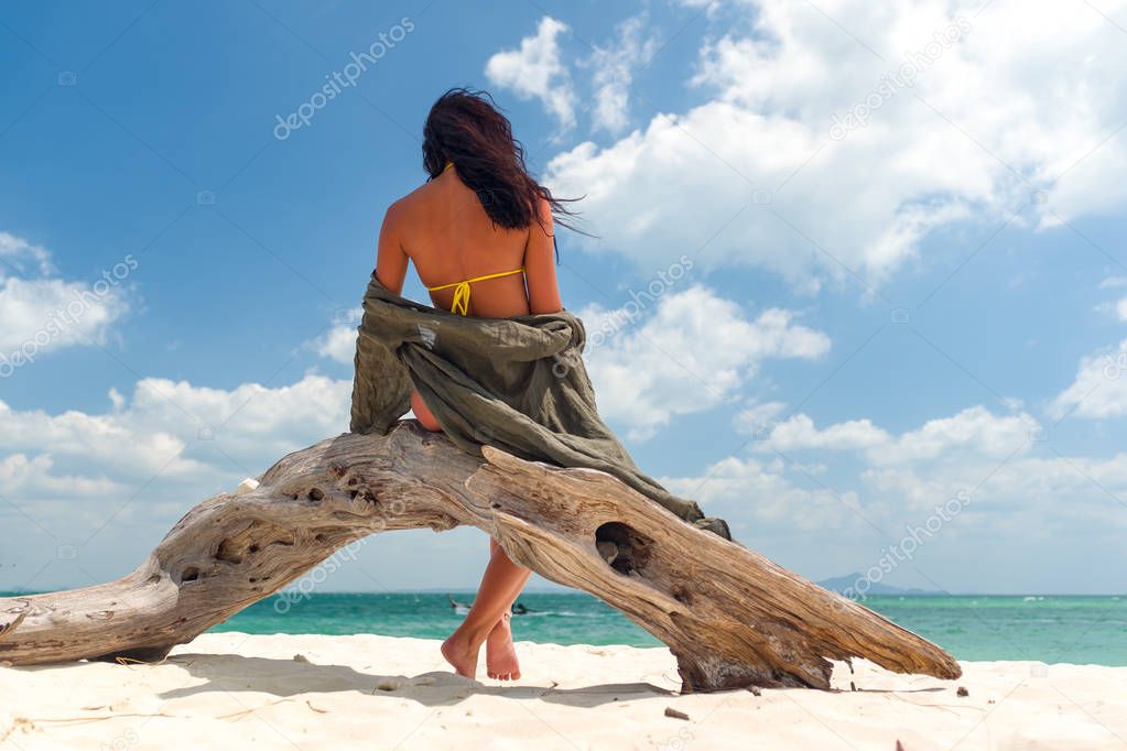 Woman enjoying her holidays on a transat at the tropical beach 