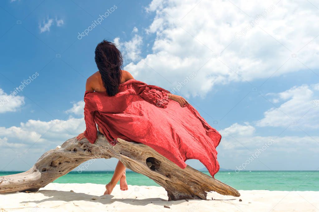Woman enjoying her holidays on a transat at the tropical beach 
