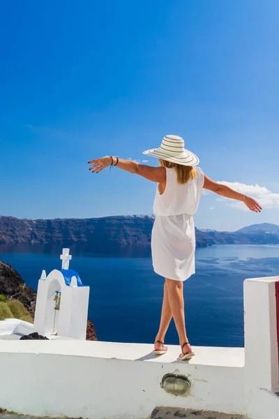 Luxe reizen vakantie vrouw kijkt aan uitzicht op Santorini eiland — Stockfoto