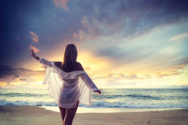 Woman on the beach at sunset in Asia