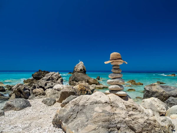 Ψάθινο Καπέλο Στην Παραλία Πάνω Ισορροπημένες Πέτρες — Φωτογραφία Αρχείου