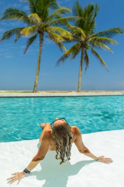 Beş yıldızlı lüks bir kadın, yüzme havuzunda tropik bir tatil köyü.. 