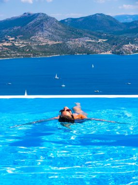 Yunanistan 'da sonsuz yüzme havuzunda bir kadın