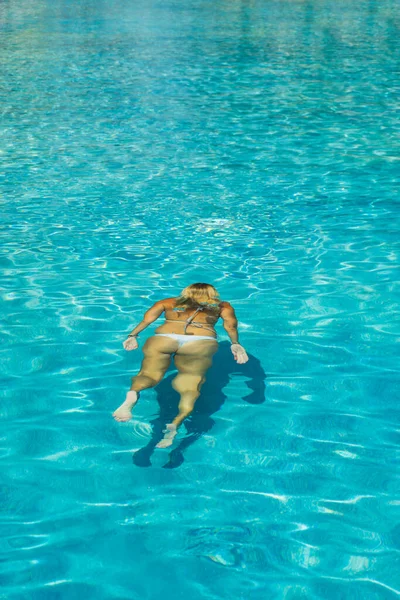 Woman in bikini at swimming pool underwater