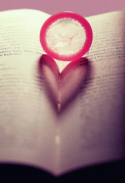 Red Condom Heart Open Book — Stock Photo, Image