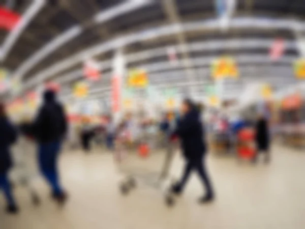 Pessoas fazendo compras em loja de departamento tema borrão fundo — Fotografia de Stock