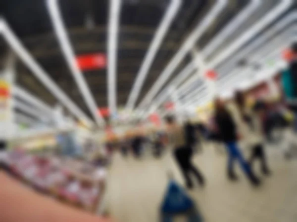 Människor shopping i varuhuset tema oskärpa bakgrund — Stockfoto