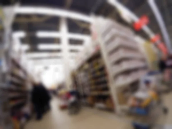 Människor shopping i varuhuset tema oskärpa bakgrund — Stockfoto