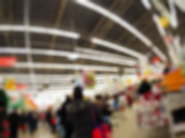 Människor shopping i varuhuset tema oskärpa bakgrund — Stockfoto