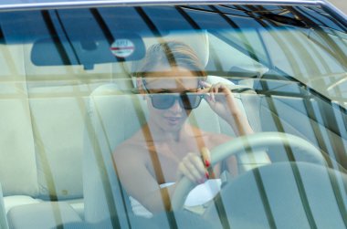 Kadın araba kullanıyor.