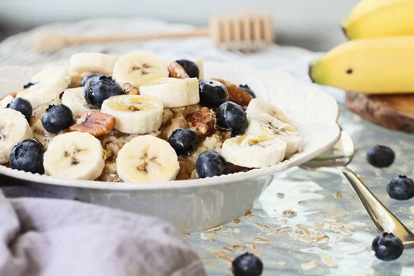 Hot Breakfast Healthy Oatmeal Pecans Bananas Blueberries Honey Rustic Background — Stock Photo, Image