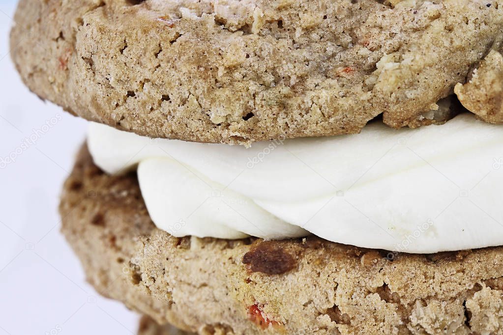 Abstract of an extreme close up of a Carrot cake raisin cookie sandwich stuffed with cream cheese icing. Extreme shallow depth of field.