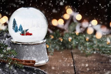 Çamın dalları, tarçın ve yavaşça düşen ile sıcak bir gri eşarp çevrili bir Noel ağacı çekme tuck eski almak ile kar küresi rustik görüntüsü kar pul.