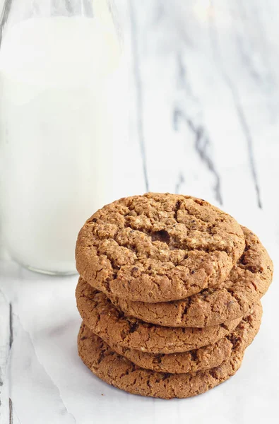 Stack of Oatmeal cookies with glass of milk from Overhead — Stock Photo, Image