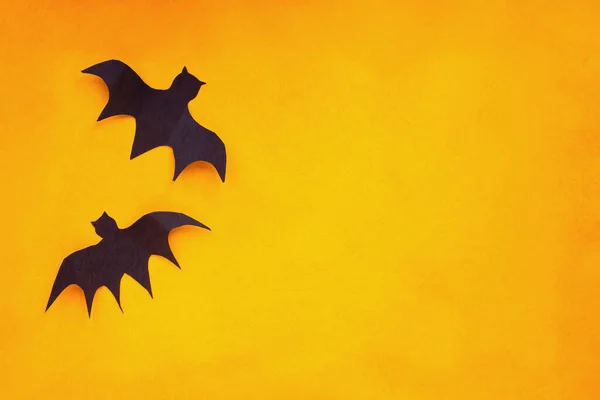 Halloween Holiday Decorations Two Paper Bats Flying Empty Orange Background — Stock Photo, Image