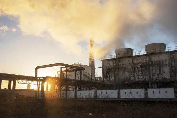 Factory steam in the sunset sun — Stock Photo, Image