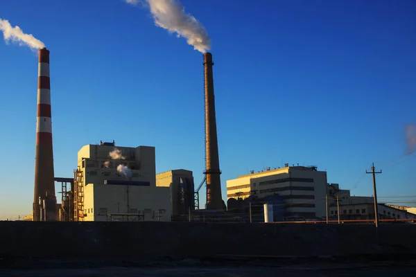 Factory cooling tower steam at sunset — Stock Photo, Image