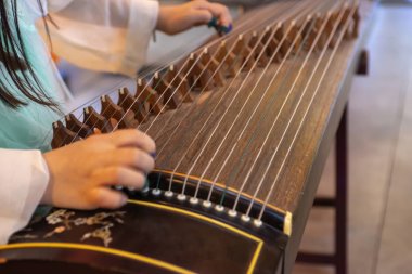 Playing the Chinese zither clipart