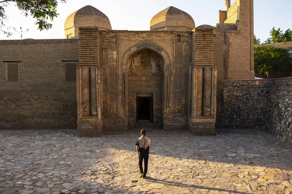 The museum of carpet weaving, former Magoki-Attari mosque, Bukhara, Uzbekistan. Man going to the entrance