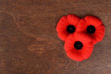 closeup of three remembrance day poppies clipart