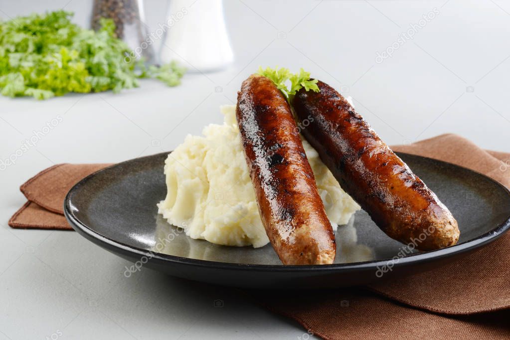 two chorizo sausages with mashed potato