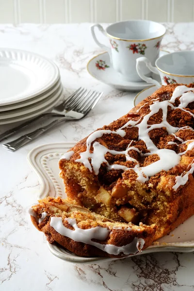 closeup cut apple fritter loaf cake with icing