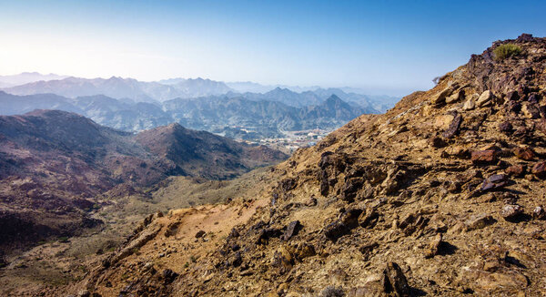 Scenic overlook of Al Hajar mountains in emirate of Fujairah, UAE and village in valley