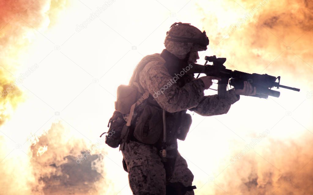 Soldiers silhouette on background of fire explosion