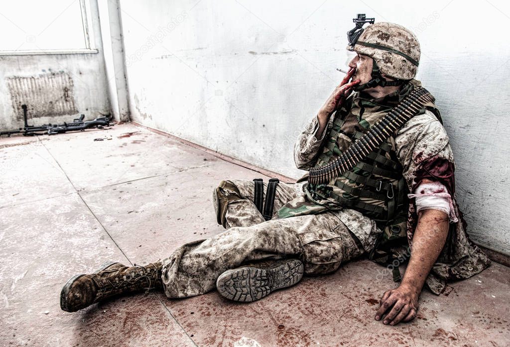 Wounded marine smoking after receiving medical aid
